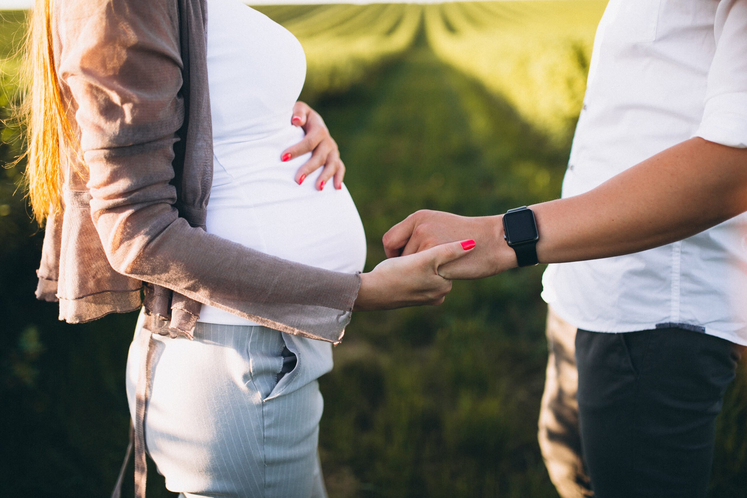 pregnant-woman-with-her-husband-in-park